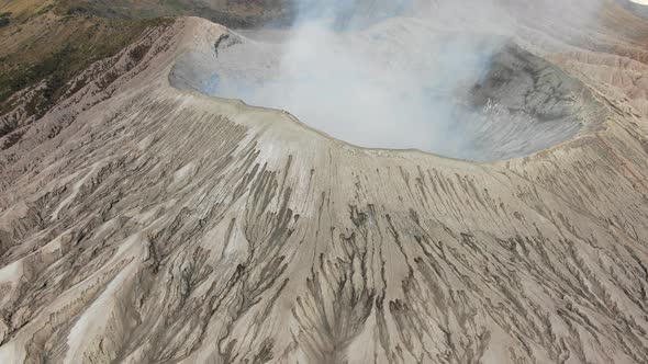 Mount Bromo is smoky active volcano with crater