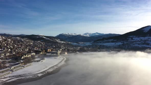 Winter sunrise at Voss Norway - Aerial panoramic view of town with morning frost haze floating over