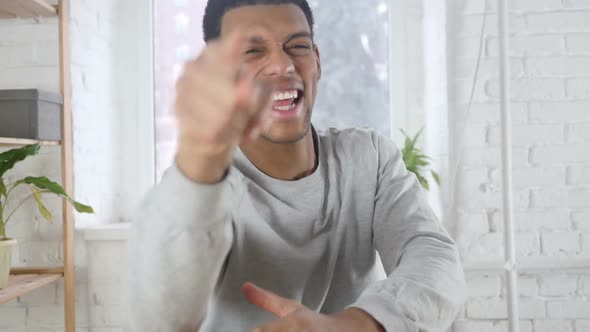 Portrait of Handsome Happy AfroAmerican Man Celebrating Success Indoor