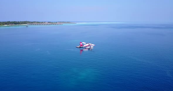 Tropical aerial island view of a summer white paradise sand beach and blue ocean background in high res