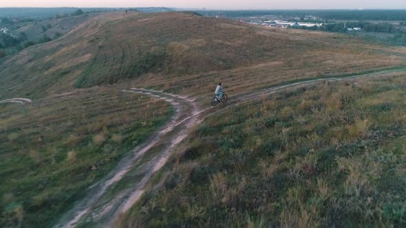 Aerial View of Guy Rides a Bicycle alt