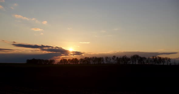 Twilight. Sunset On A Background Of Trees. Timelapse Of Clouds