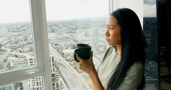 Woman having coffee at home 4k