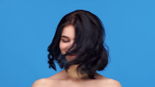 Studio portrait of young and beautiful brunette woman.