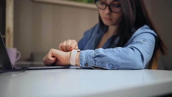 Young Woman Using Smart Watch at Home