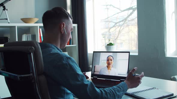 Young male entrepreneur works at home office at the computer.