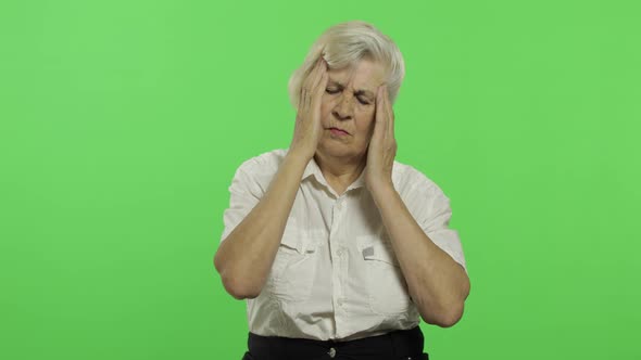 An Elderly Woman Suffer By Headache Pain Trouble. Old Grandmother. Chroma Key