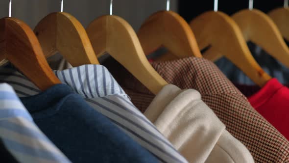 Hangers with Different Clothes in Wardrobe Closet