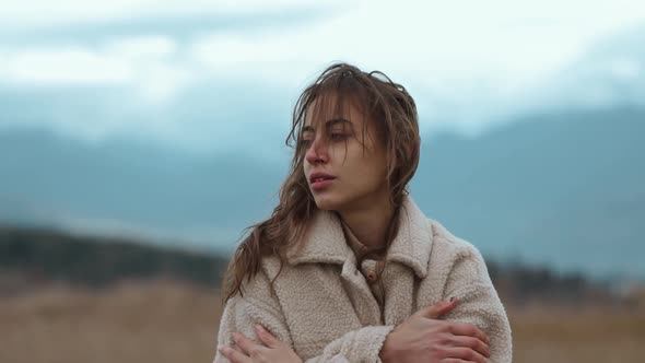 Close Up Portrait of Disappointed Ukrainian Woman Stands Outdoors at Cold Cloudy Autumn Day