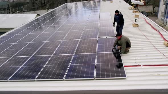 Solar Technician Installing Solar Panels on House Roof