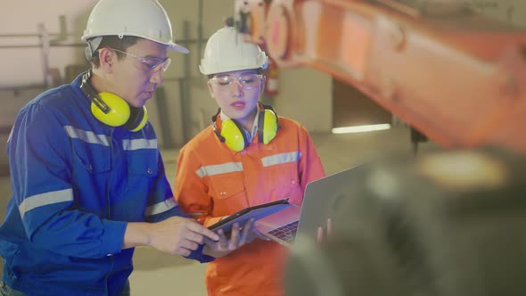 asian male engineer specialist with Measuring machine with a manipulator arm