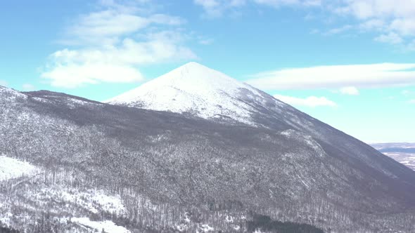 Snow all over the top of Rtanj mountain 4K drone footage