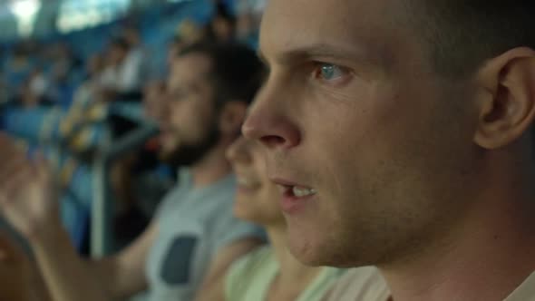 Closeup of Football Fan Clapping, Watching Game With Friends at Stadium, Slow-Mo