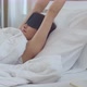 Asian young woman waking and touching alarm clock - VideoHive Item for Sale