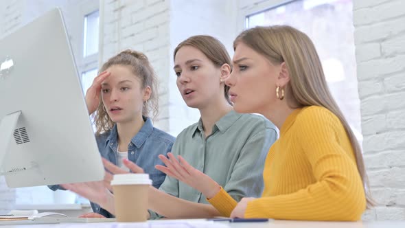 Disappointed Female Startup Team Reacting To Failure on Desktop