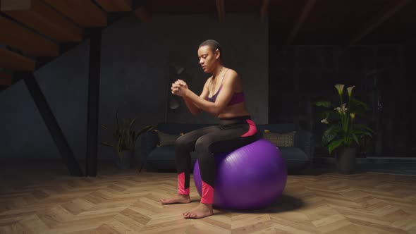 Fit Female Doing Basic Bounce Exercise on Fitball