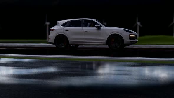 White Luxury SUV Fast On Long Rainy Road