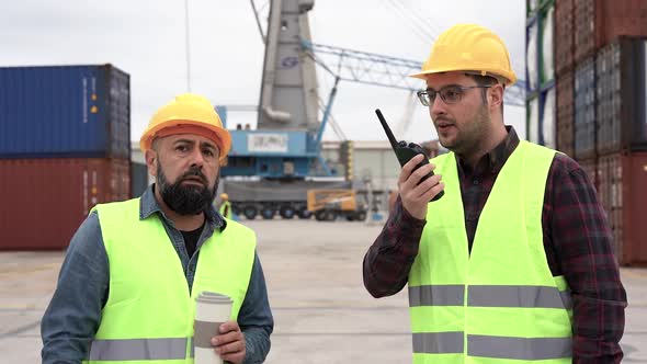 Men working on harbor controlling container