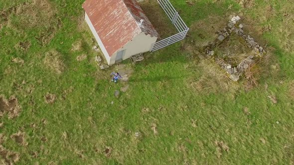 Aerial view of a trail runner and a small house.