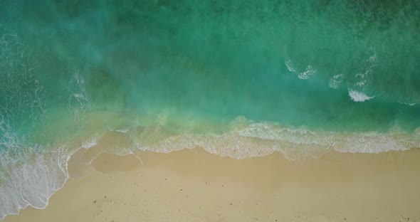 Tropical aerial tourism shot of a white paradise beach and blue water background in best quality 4K