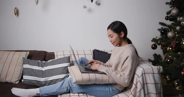 Asian Business Woman Use Computer and Work From Home in the Evening on Holidays