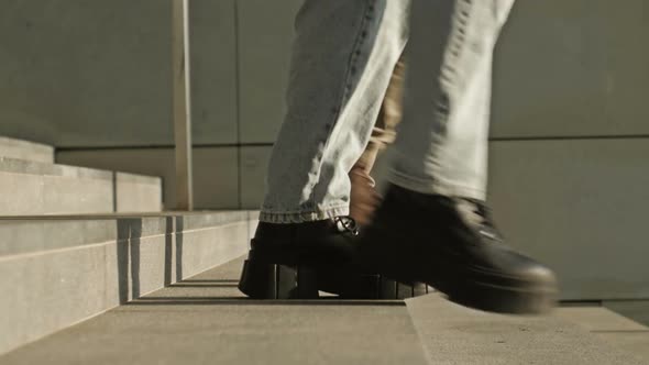 Legs of Different People Going Down the Stairs of an Underpass or Subway