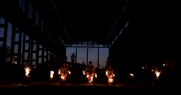 Slow Motion Fire Show in the Hangar Show Three Female Artist and a Man with Flamethrowers