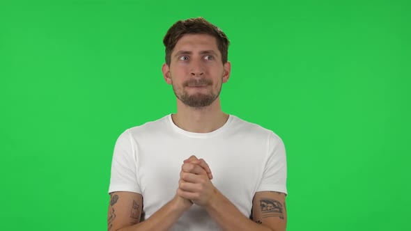 Portrait of Confident Guy Is Waiting in Anticipation with Pleasure. Green Screen