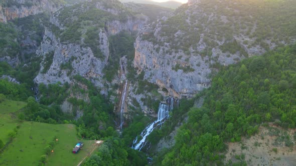 aerial drone view Ujevara E Sotires wild waterfalls in Nivica Canyon with cliffs of karst gorge with