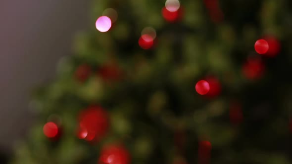 Blinking lights on christmas tree out of focus