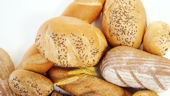 Various bread loaves with wheat grains