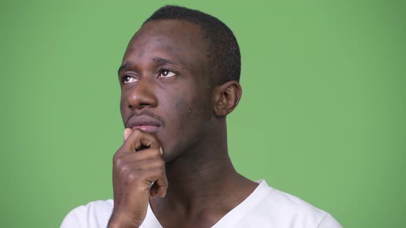 Young African Man Against Green Background