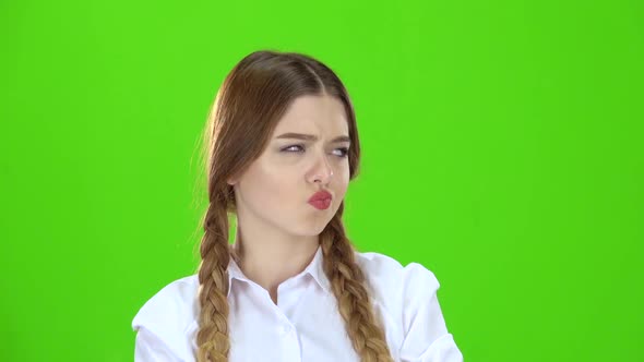 Student in a White Blouse and Pigtails Shows a Fist . Green Screen