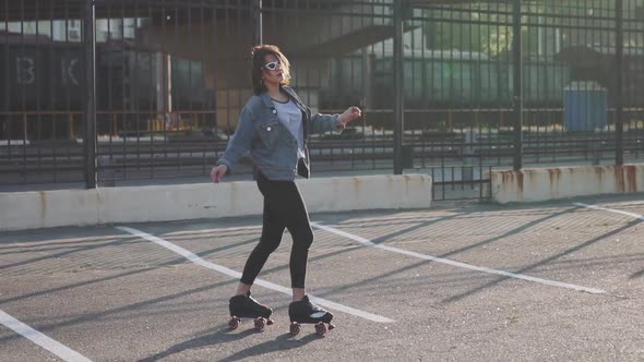 Attractive Beautiful Young Woman Riding Roller Skating and Dancing in the Streets