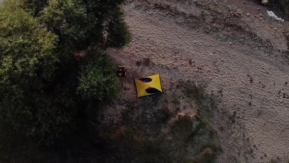 A Traveler Rests in the Shadow of a Tree on the River Bank