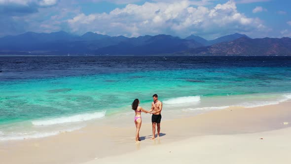 Fun People on Honeymoon Vacation Enjoy Life on Beach on Sunny White Sandy