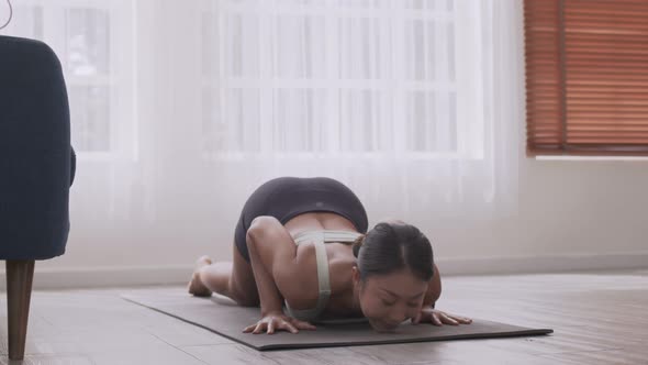 Asian woman practising yoga, Cobra exercise,