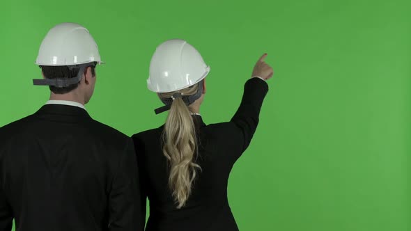 Rear View of Female Construction Engineers Pointing Up Chroma Key