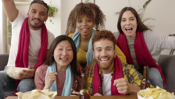 Excited Young Friends or Multiracial Football Fans Watching Sports on TV