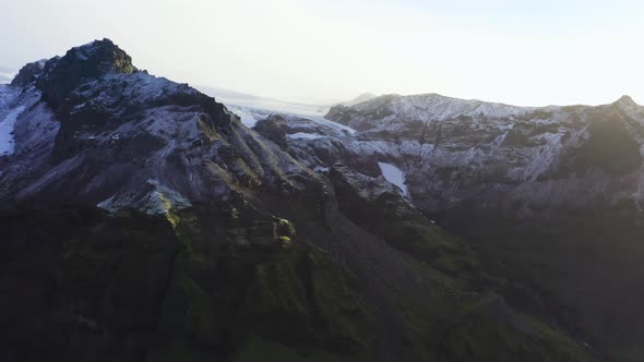 Drone Arcing Over Mountain Peak With Vatnajokull Glacier