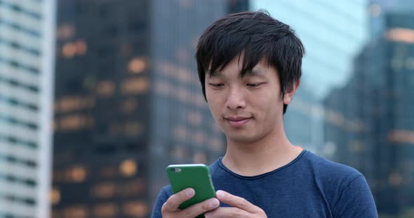 Man look at smart phone at outdoor park