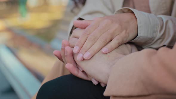 Close Up Young Couple in Love Hold Hands Sitting on Bench Unrecognizable Girl and Guy on Romantic