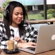 Happy young black woman make video call online chat look at laptop screen sit in cafe. - VideoHive Item for Sale