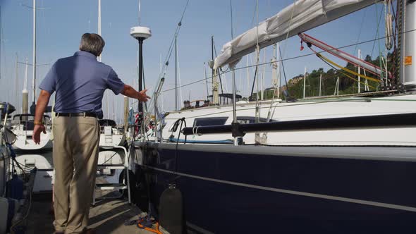 Senior couple get on sailboat. Shot on RED EPIC for high quality 4K, UHD, Ultra HD resolution.