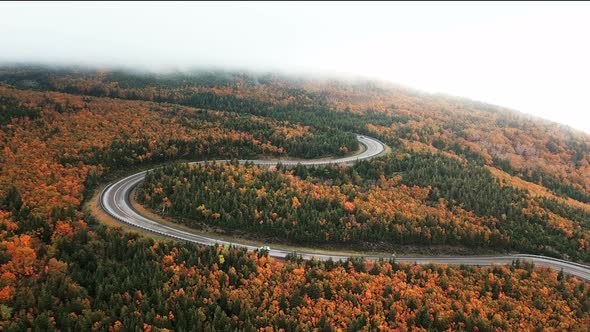 Aerial views of the world famous Cabot Trail as a car drives along scenic road