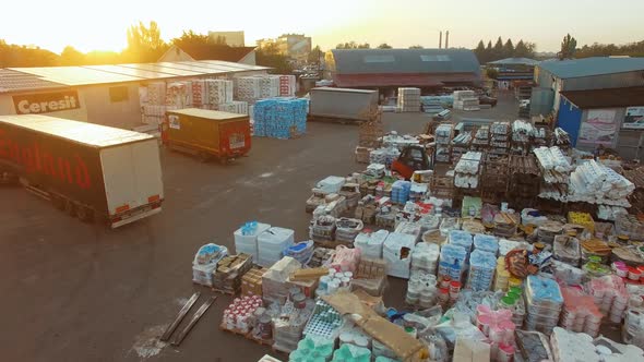 Logistics from above. Aerial view of warehouse with trucks