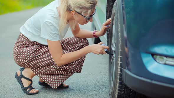 Frustrated Woman Repairing Flat Tire Check Pressure Accident Car. Broken Vehicle Damage Troubles.