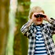 Boy Looking Through Binoculars While Hiking In Woods - VideoHive Item for Sale