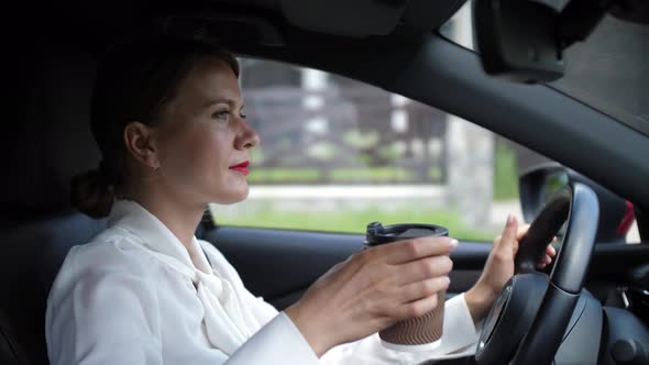 Pretty Woman Enjoying Coffee Drink Driving Car