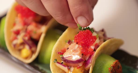 Sushi Tacos - Chef Garnishing The Tacos With Chopped Onion Chives. - close up shot